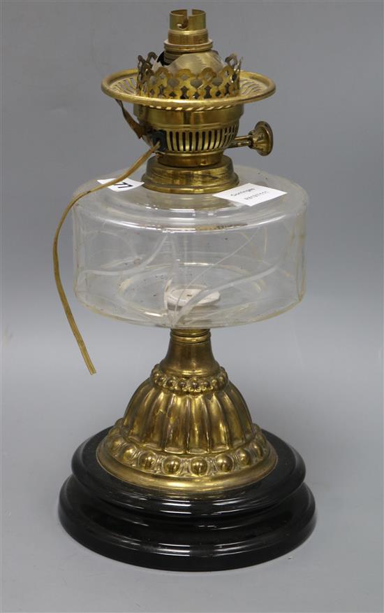 A Victorian brass and glass oil lamp, on black ceramic base height 34cm